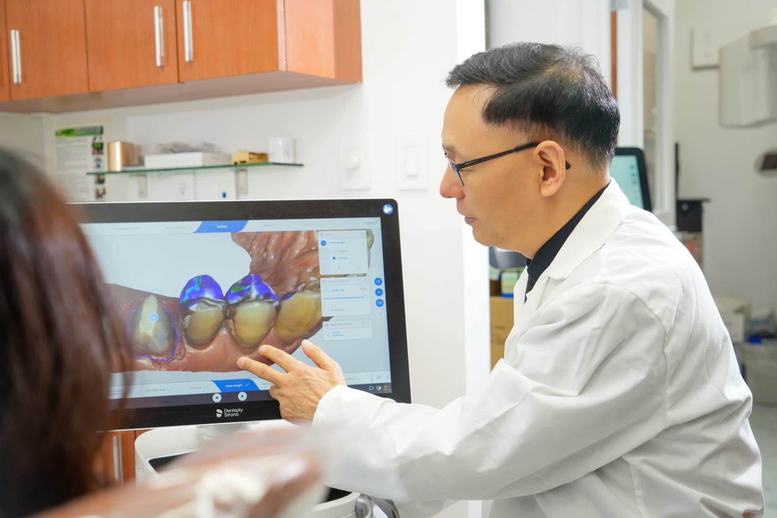 Dr. John Shi reviewing a patient 3D scan on screen at Centre Dental NYC